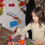 Youth artist Abby picking out colors for the mural with mom, Lisa already busy at work