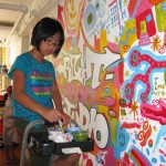 Miya adds her funky eyeball designs to our mural