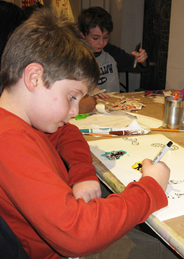 Youth artist Adam participates in a "$5 Fridays" workshop