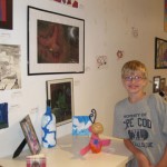 Matthew stands next to his phoenix drawing at the "Art in the Air" youth art show May 2011