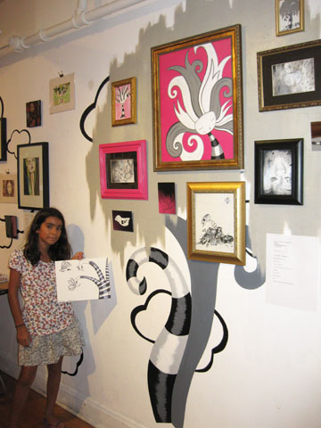 Youth Artist Caroline, age 11, is inspired by the art on the walls at Right-Brained Studio, during "The Candy Store" Pop-Up Gallery Art Show.