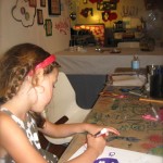 Elisse gets her inspiration for her purple skull drawing from Chicago artist "Blutt" during one of our Artist Inspired Workshops at "The Candy Store" Pop-Up Gallery