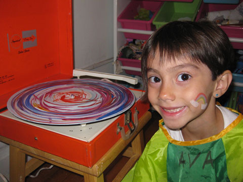 Ava painting a "Rad Record" on a record player!