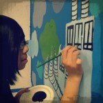 Miya works on our mural.